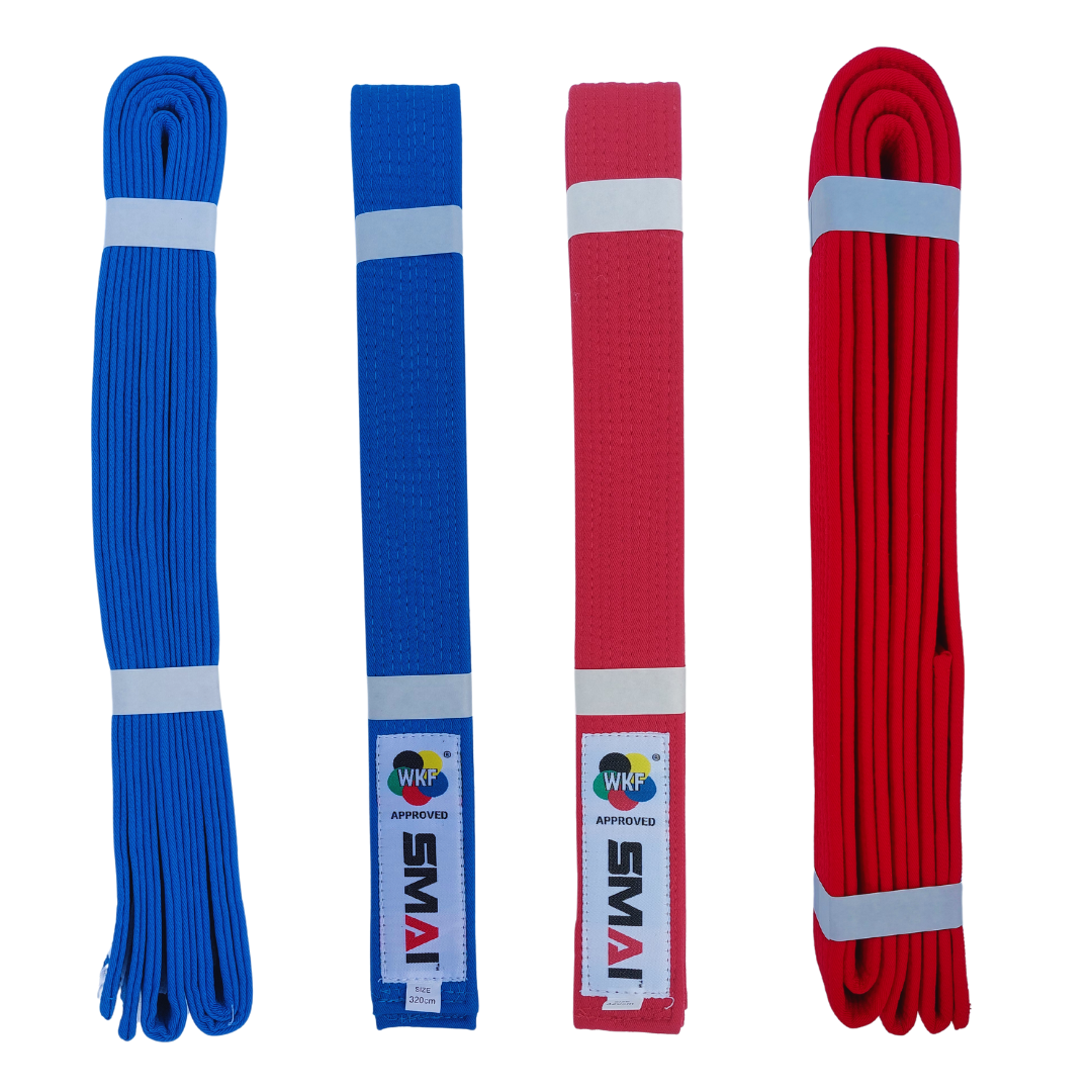 Two neatly folded red and blue karate belts against a white background. The belts feature a clean, bright red and blue color and appears to be made of a thick, woven textile, indicative of good quality material. Prominently displayed on one end of the belt is a rectangular label with the SMAI logo and the text "WKF APPROVED", signifying its suitability for use in World Karate Federation sanctioned events.