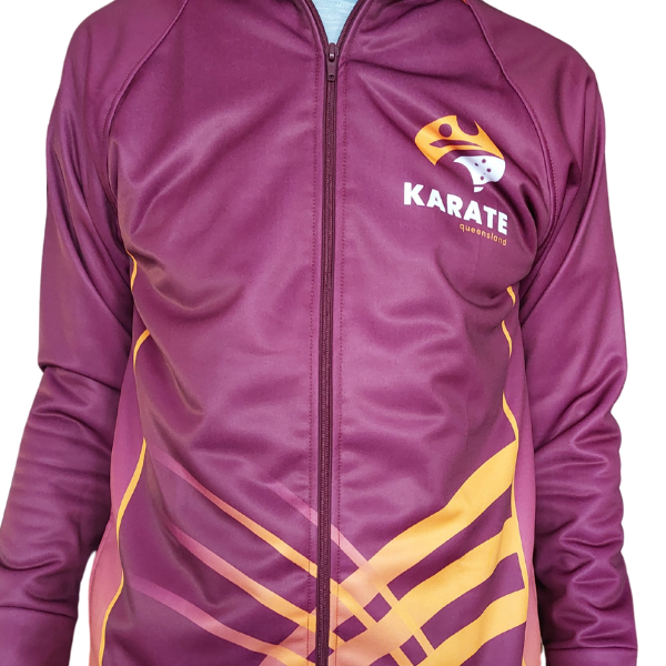The official Karate Queensland tracksuit top shown from the front, worn zipped up. The design features a bold maroon base with dynamic gold detailing across the lower half and sides, and the Karate Queensland logo prominently displayed on the chest.